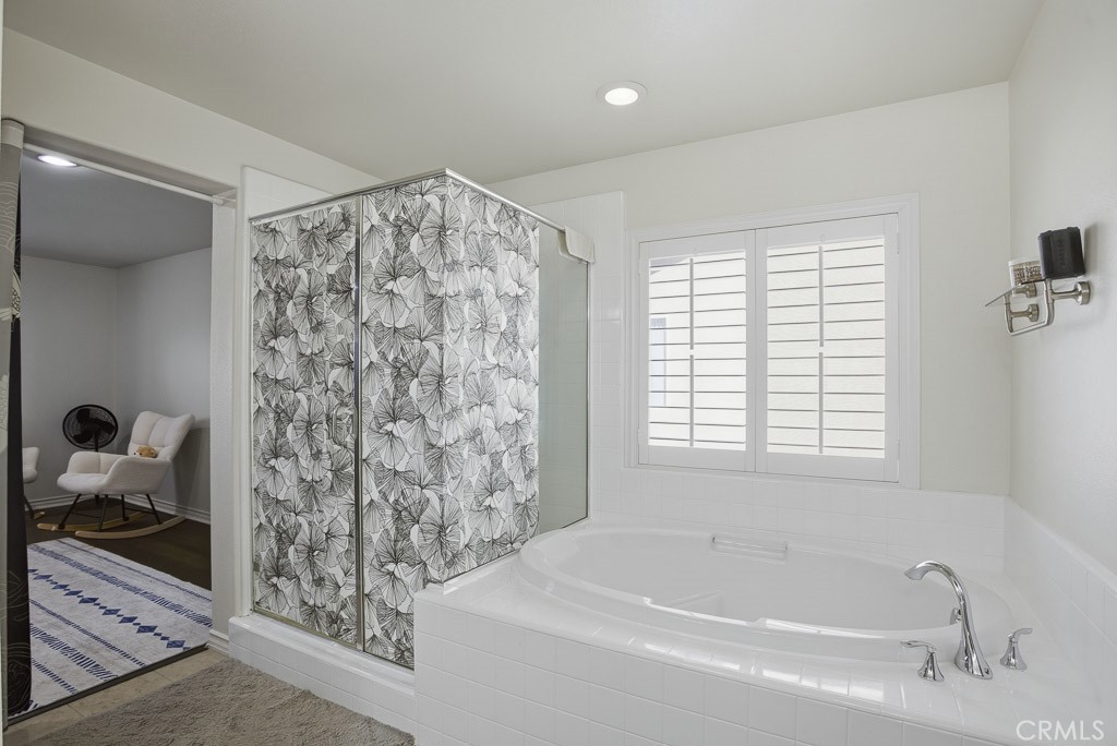 6865 Hop Clover Road Eastvale, CA 92880 - Photo 48 of 59 a bathroom with a bathtub and shower
