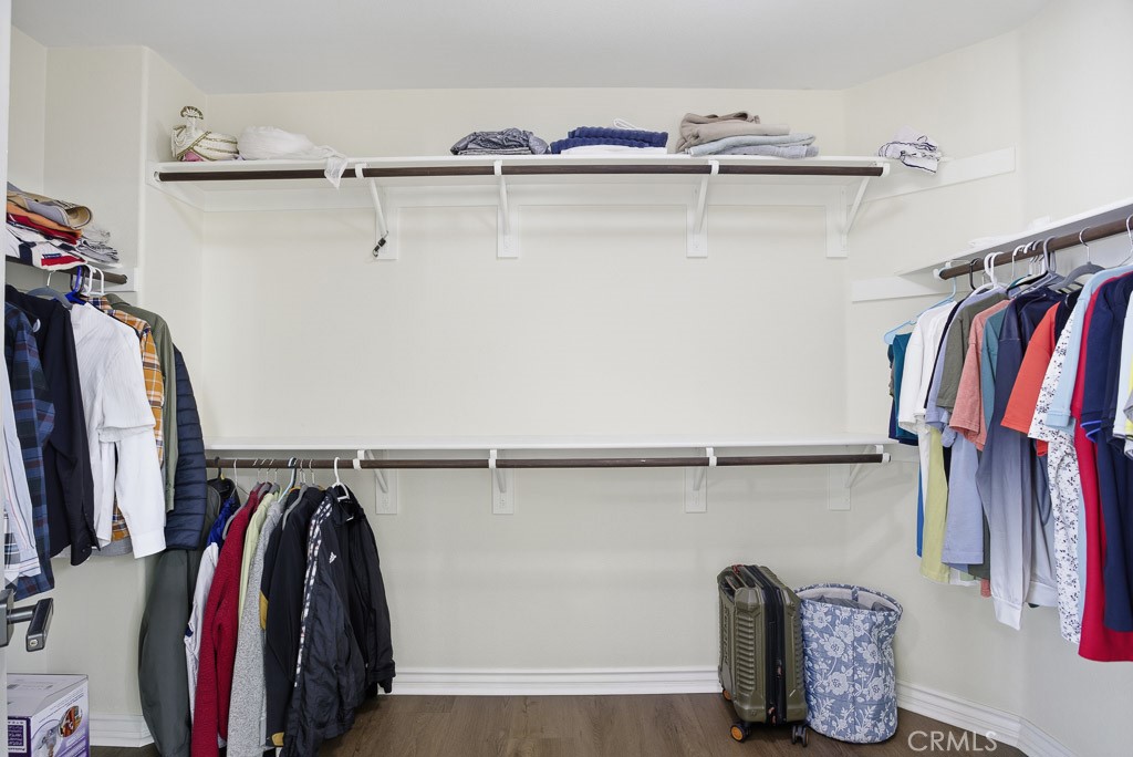 6865 Hop Clover Road Eastvale, CA 92880 - Photo 50 of 59 a view of walk in closet with clothes and shoes