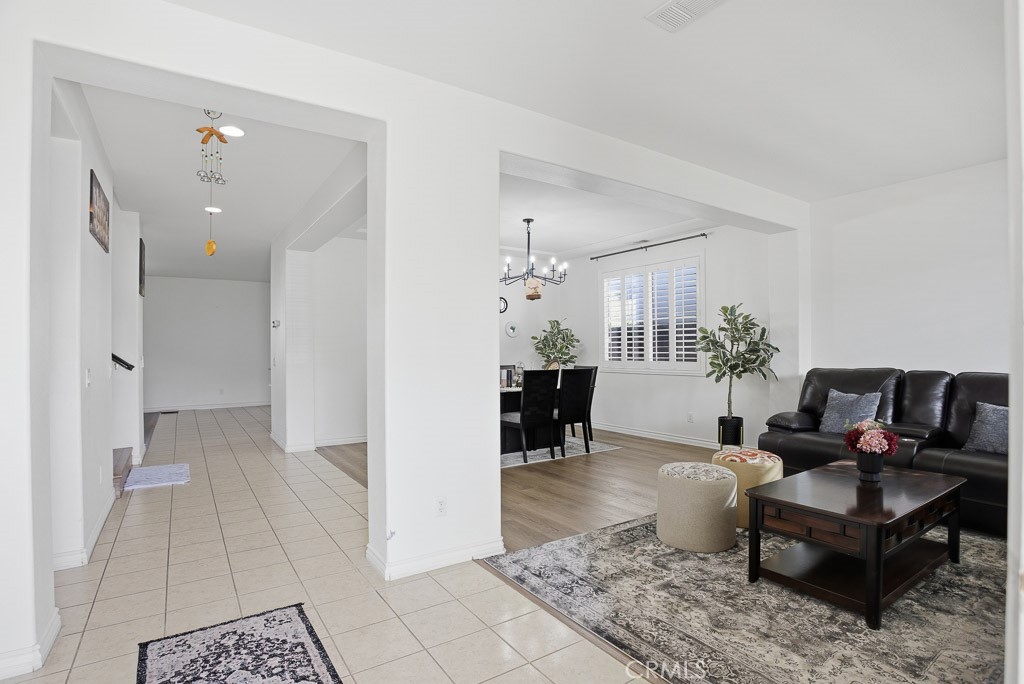 6865 Hop Clover Road Eastvale, CA 92880 - Photo 5 of 59 a living room with furniture and a dining table