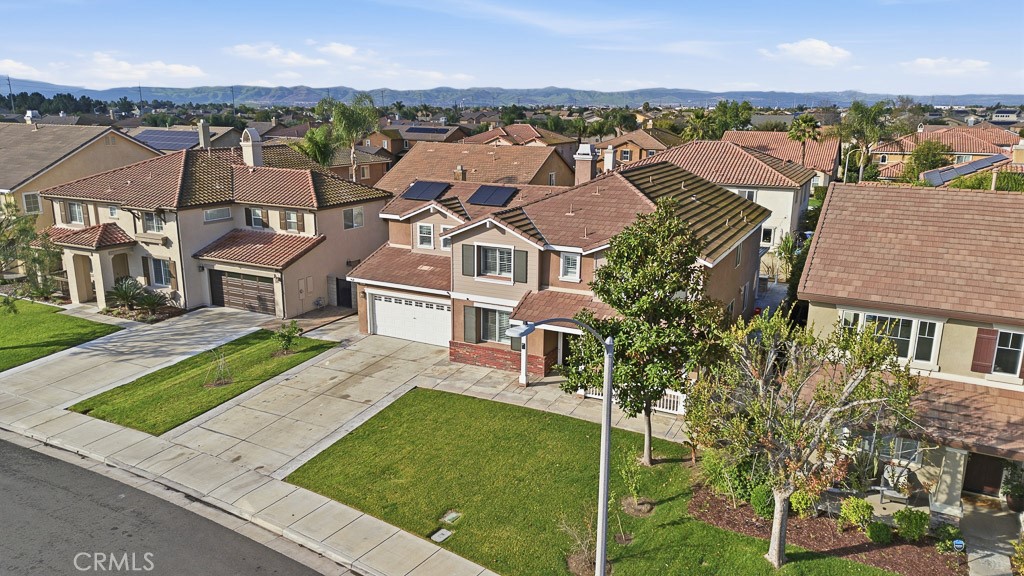 6865 Hop Clover Road Eastvale, CA 92880 - Photo 57 of 59 an aerial view of residential houses with outdoor space and trees