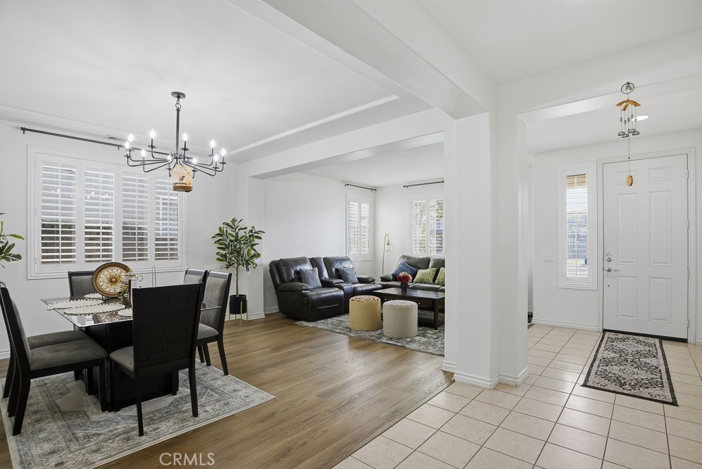 6865 Hop Clover Road Eastvale, CA 92880 - Photo 6 of 59 a living room with furniture and a chandelier