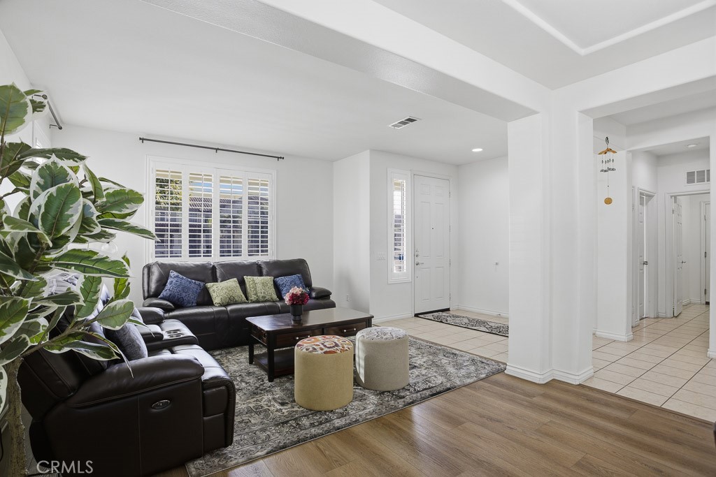 6865 Hop Clover Road Eastvale, CA 92880 - Photo 8 of 59 a living room with furniture and a window