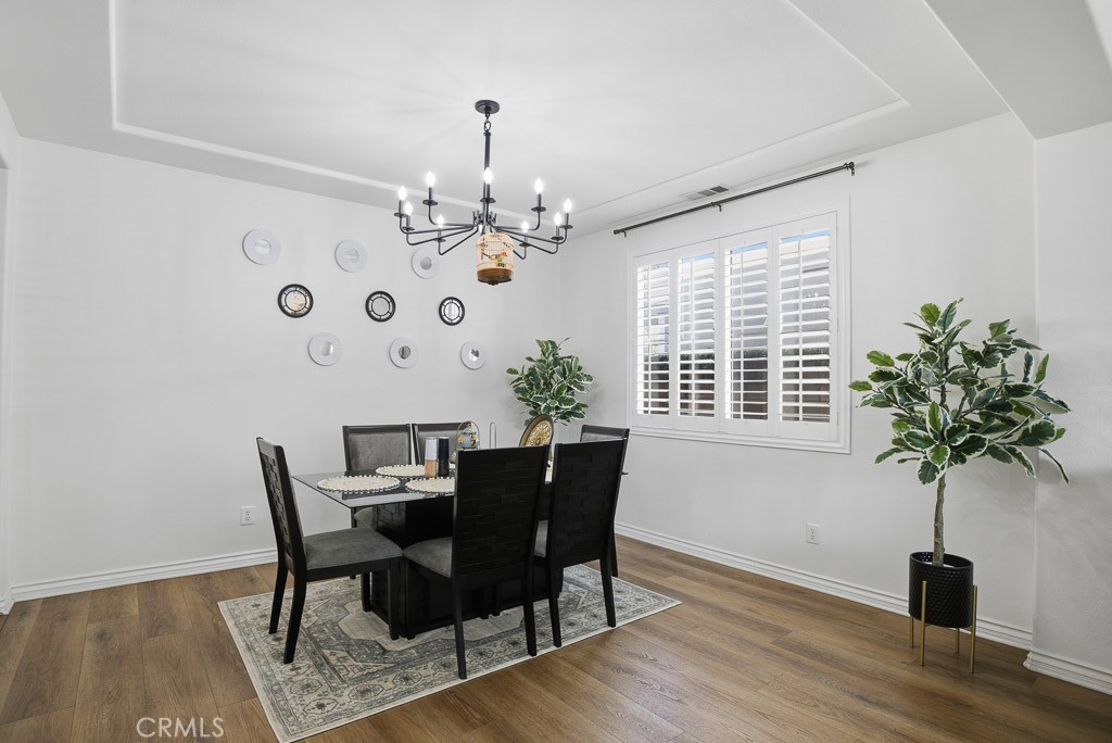 6865 Hop Clover Road Eastvale, CA 92880 - Photo 10 of 59 a view of a dining room with furniture window and wooden floor