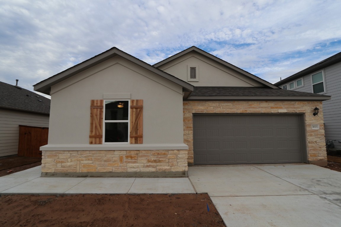 a front view of a house with yard and garage