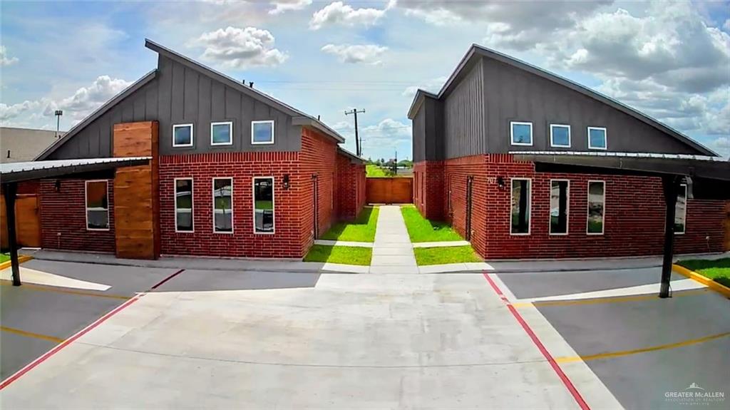 View of home's exterior featuring board and batten siding and brick siding