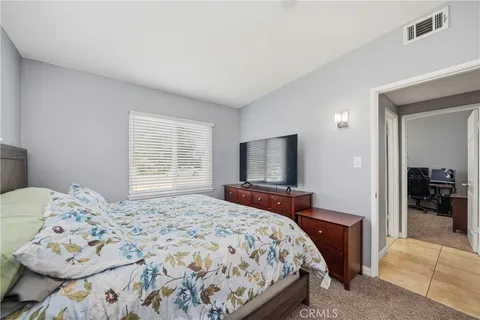 a bedroom with a bed and a television in it