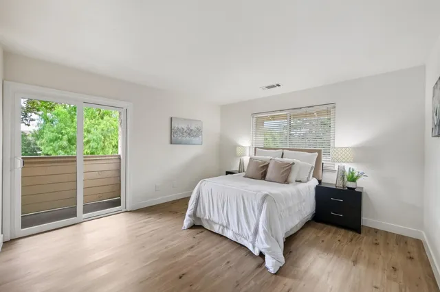 a bedroom with a bed and a large window