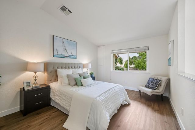 a bedroom with a bed and a window