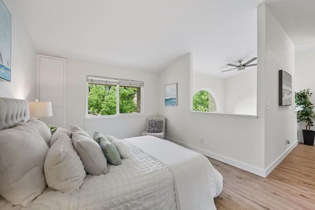 a bedroom with a bed and a window