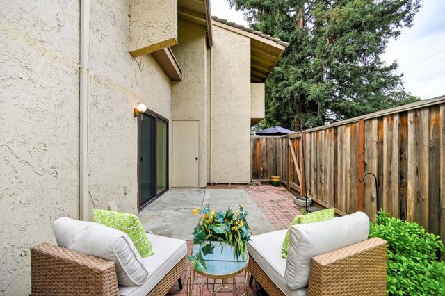 a balcony with furniture and a potted plant