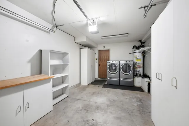 a view of a storage & utility room with two washing machine
