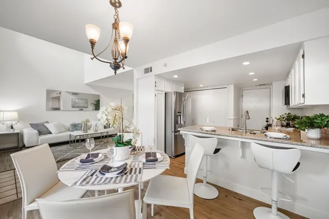 a kitchen with a dining table chairs sink and stove