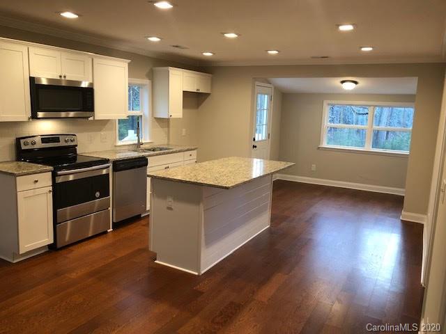 3269 Camp Creek Road Lancaster, SC 29720 - Photo 3 of 11 a large kitchen with stainless steel appliances granite countertop a stove a sink and a microwave