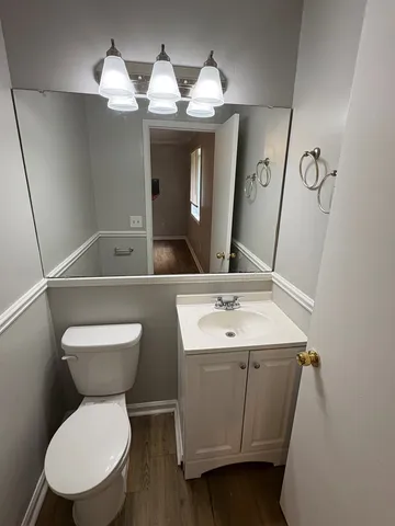 a bathroom with a toilet sink and mirror