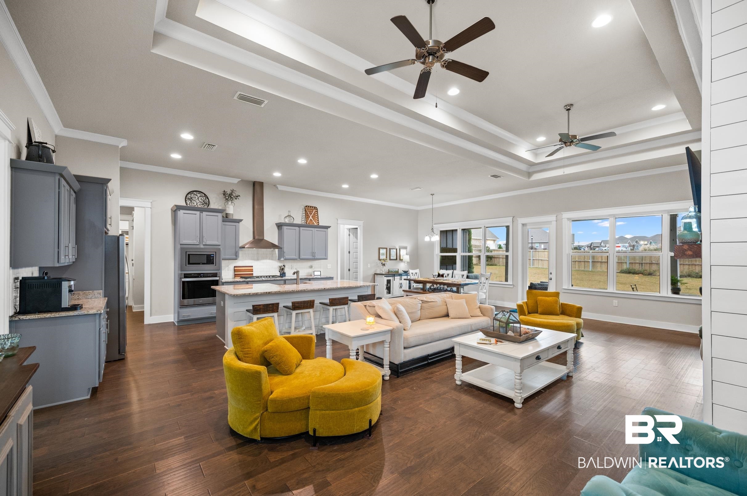 31355 Limpkin Street Daphne, AL 36527 - Photo 12 of 57 Living room featuring dark hardwood / wood-style flooring, a raised ceiling, and crown molding