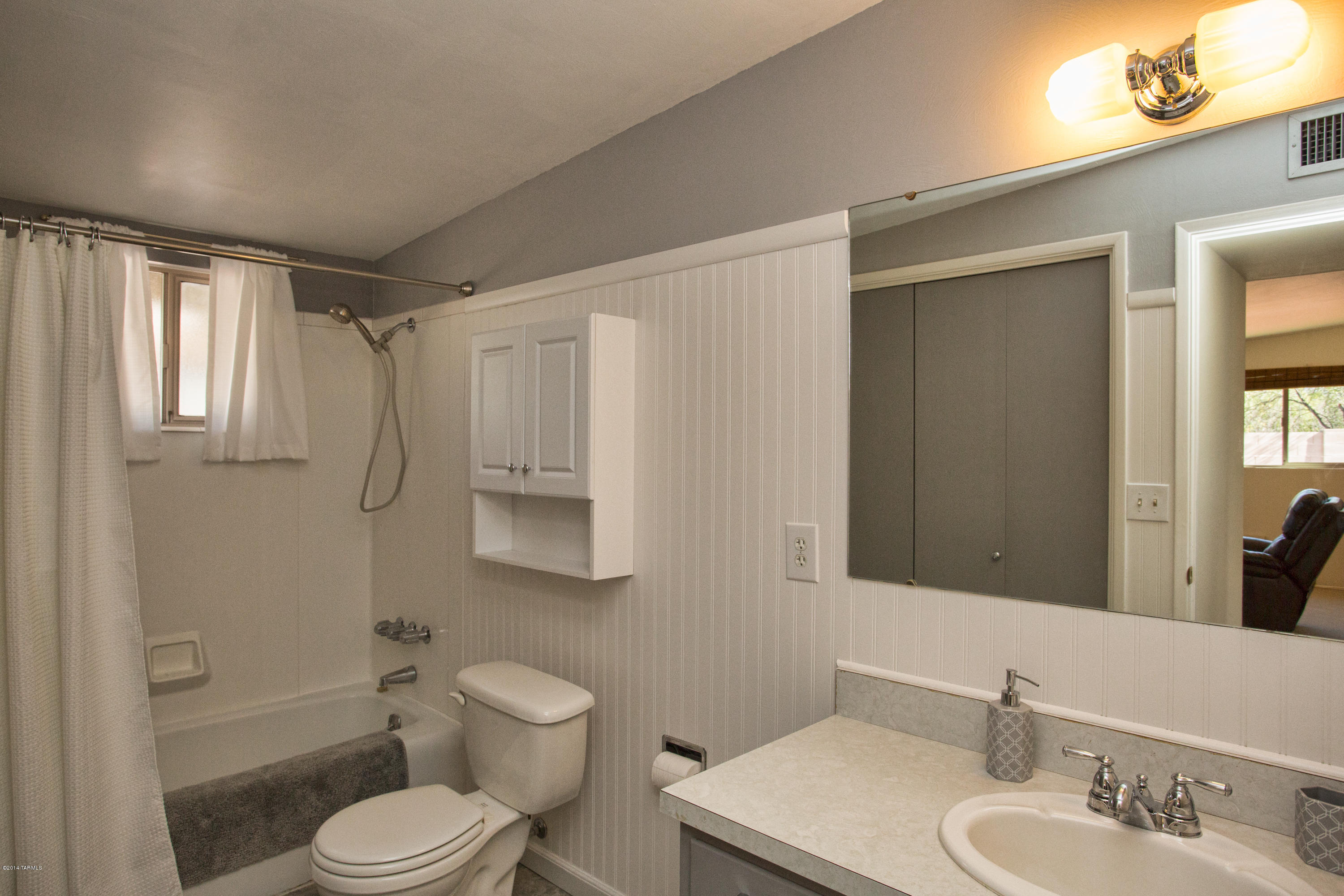 3240 North Webster Road Tucson, AZ 85750 - Photo 22 of 26 a bathroom with a toilet a sink a mirror a bathtub and vanity