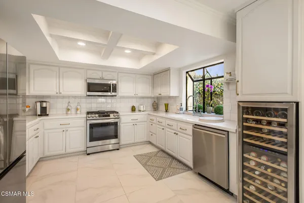 a kitchen with a sink stove and microwave