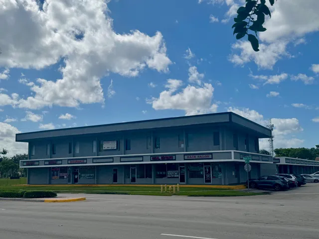 a view of a swimming pool with a bench in front of it