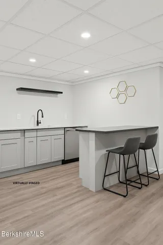 a view of a room with gym equipment and wooden floor