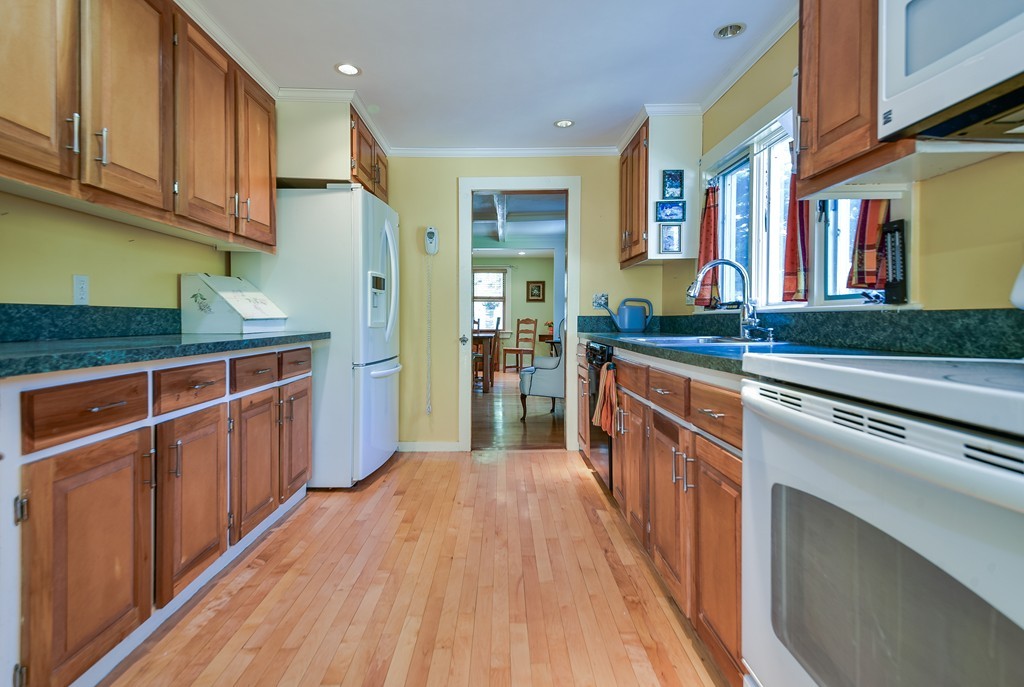 5 Lupine Road Natick, MA 01760 - Photo 15 of 29 a kitchen with stainless steel appliances granite countertop wooden cabinets a sink and dishwasher a stove with wooden floor