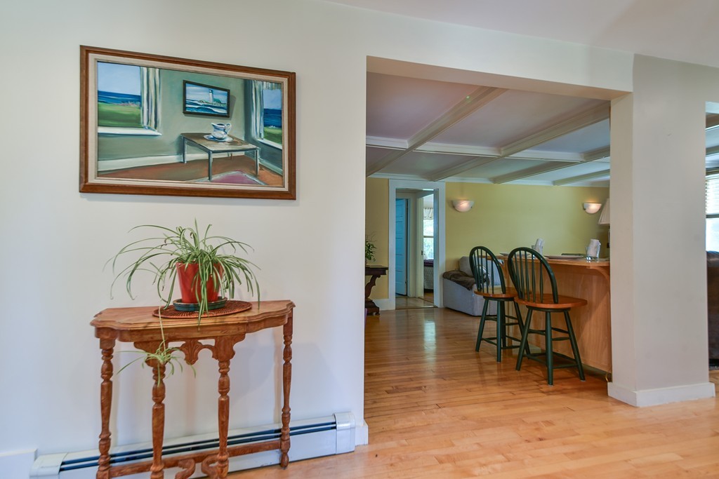 5 Lupine Road Natick, MA 01760 - Photo 3 of 29 a view of a hallway with wooden floor and furniture