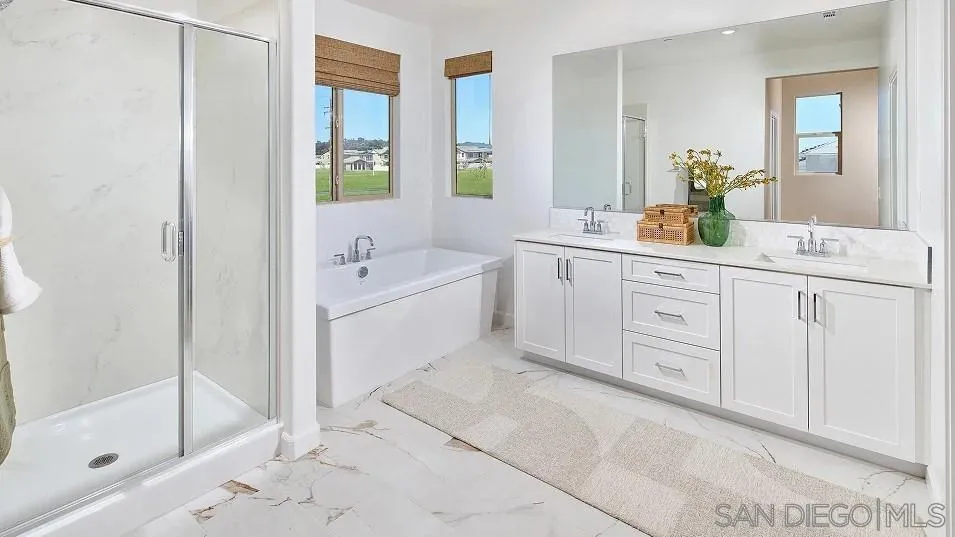 111 Metz Way Oceanside, CA 92057 - Photo 14 of 16 a spacious bathroom with a double vanity sink a mirror and a bathtub