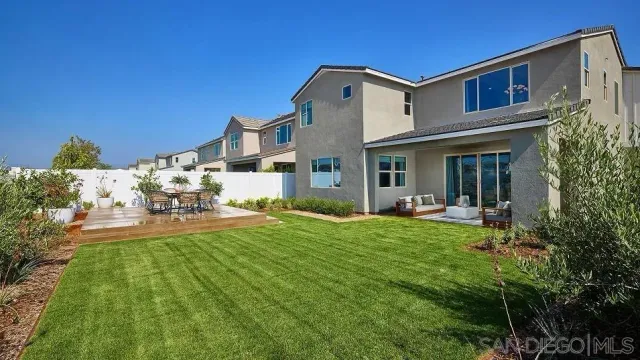 a front view of a house with swimming pool having outdoor seating
