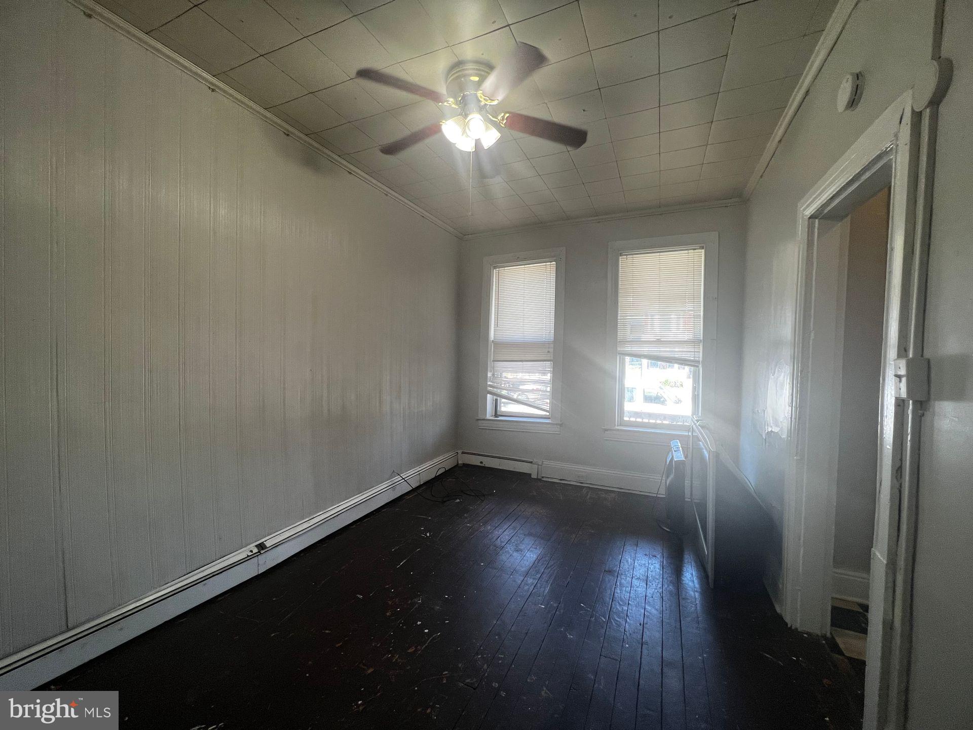 306 West Jackson Street York, PA 17401 - Photo 4 of 15 an empty room with wooden floor and windows