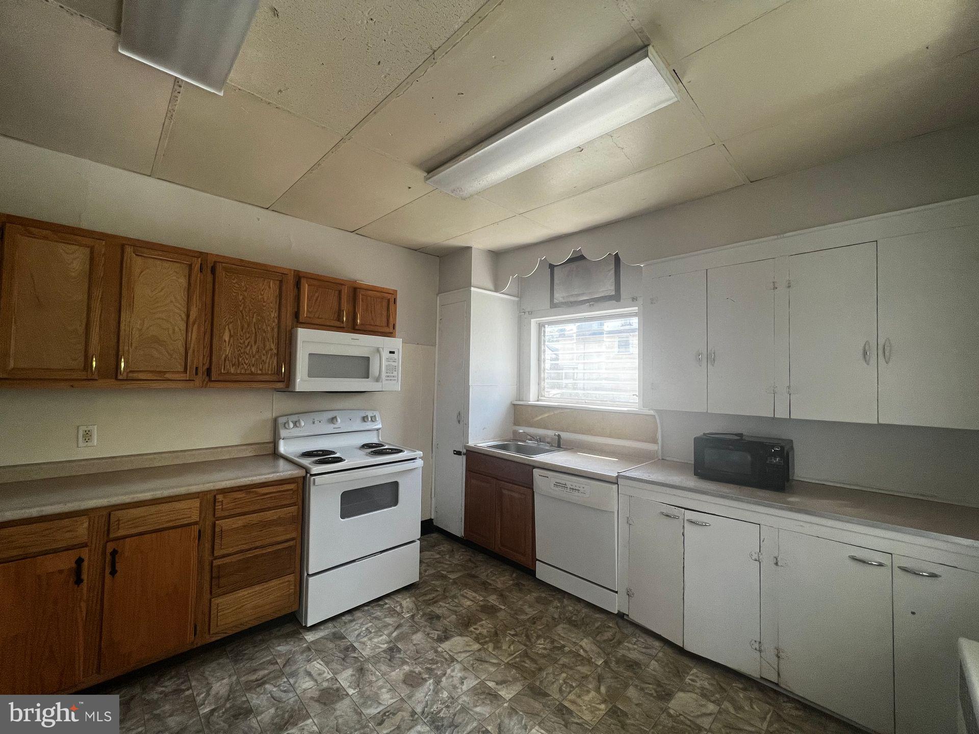 306 West Jackson Street York, PA 17401 - Photo 8 of 15 a kitchen with a sink stove and cabinets