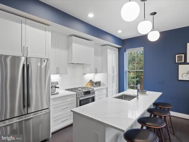 a kitchen that has a sink stainless steel appliances a counter space and a window