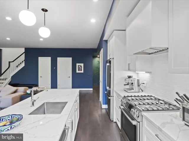 a kitchen with stove and cabinets