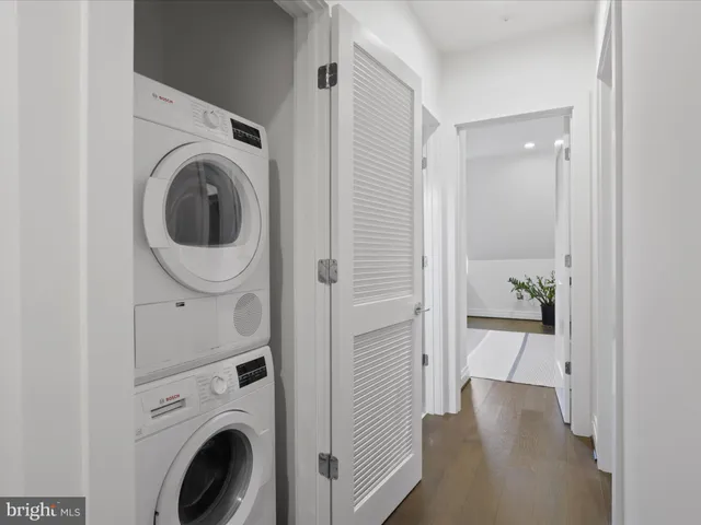 a view of a hallway with washer and dryer