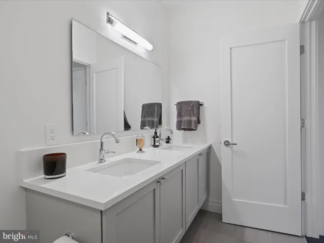 a view of bathroom with dual sinks