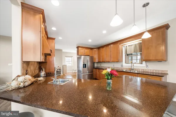 a kitchen with stainless steel appliances granite countertop a sink stove and cabinets