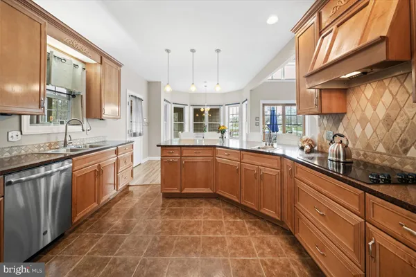 a large kitchen with stainless steel appliances and a sink