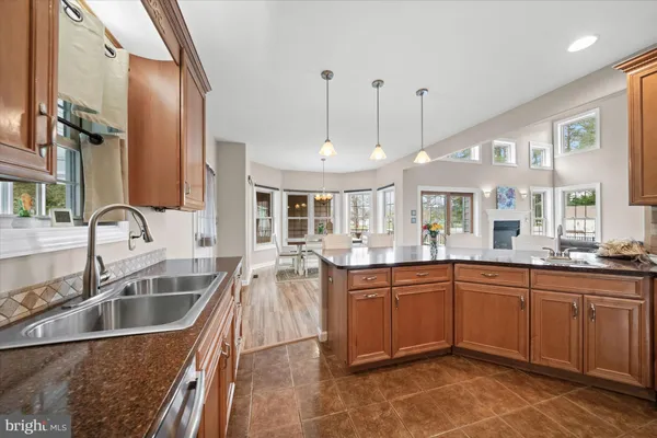 a large kitchen with a sink and cabinets