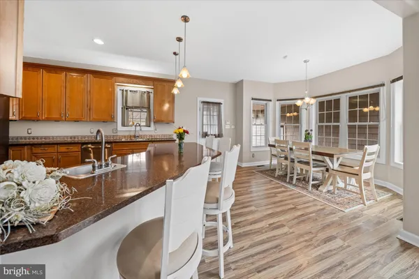 a dining table with chairs and wooden floor