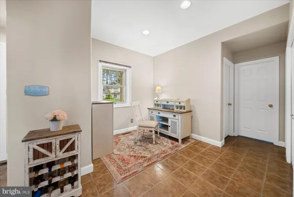 a view of room with workspace and wooden floor