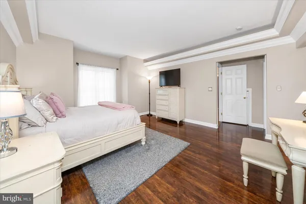 a spacious bedroom with a bed and a couch