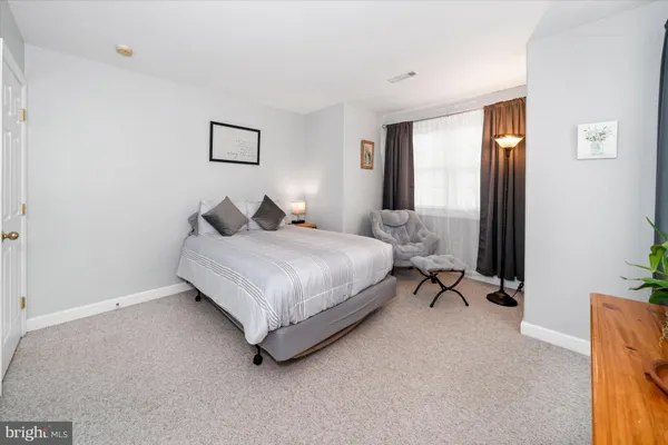 a bedroom with a bed and a mirror