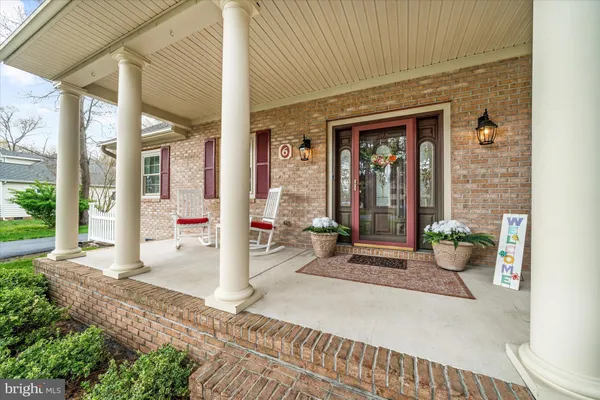 a front view of a house with outdoor seating