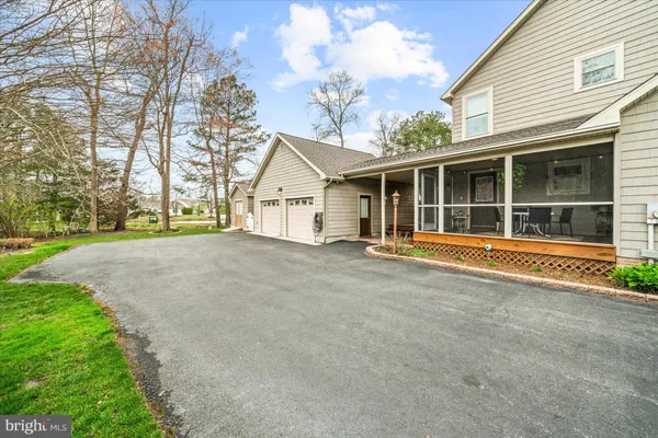 a view of a house with a yard and garage