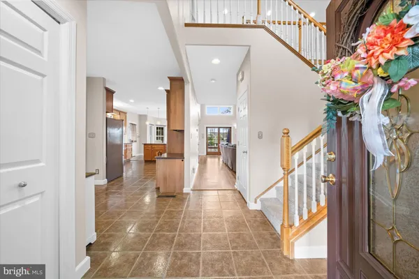 a view of a hallway with wooden floor and an entryway
