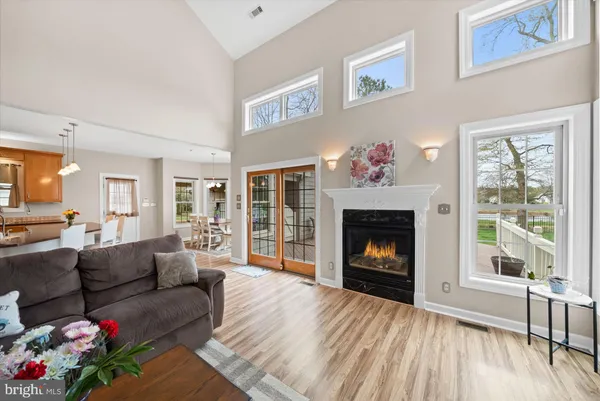 a living room with furniture a fireplace and a floor to ceiling window