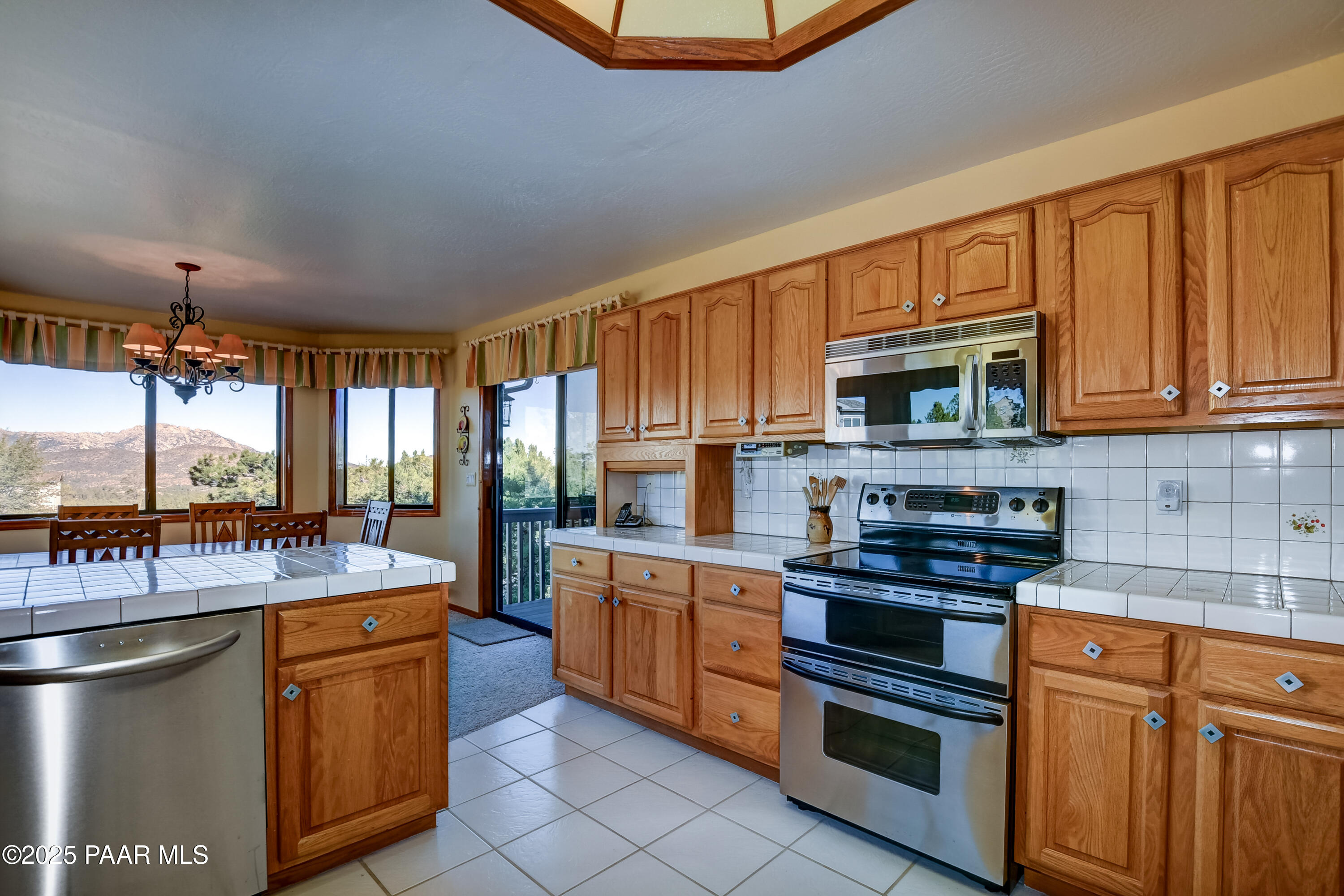 1881 Forest View Prescott, AZ 86305 - Photo 12 of 46 a kitchen with stainless steel appliances granite countertop a stove a sink and a microwave