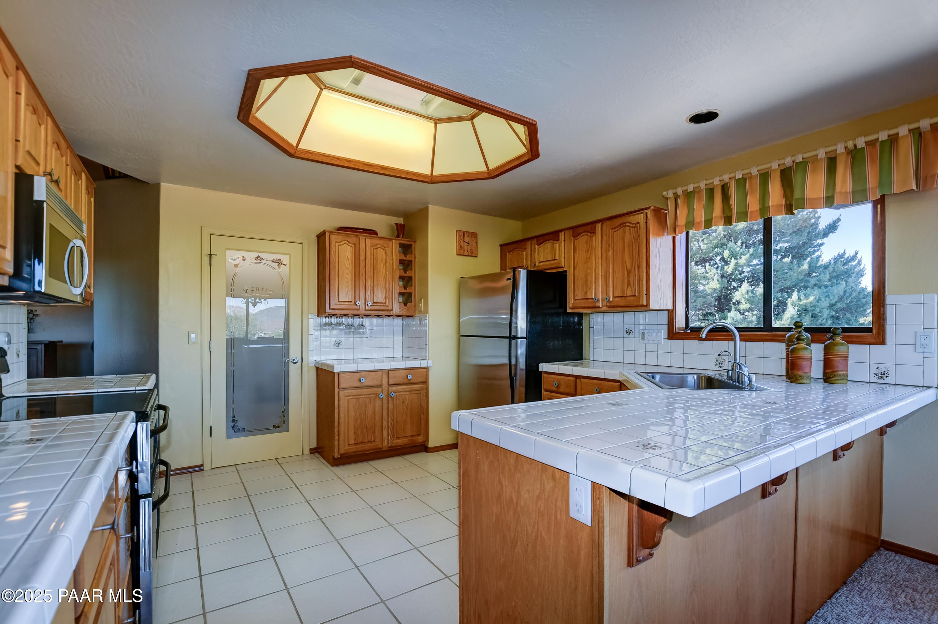 1881 Forest View Prescott, AZ 86305 - Photo 14 of 46 a kitchen with a stove a sink a refrigerator and wooden cabinets
