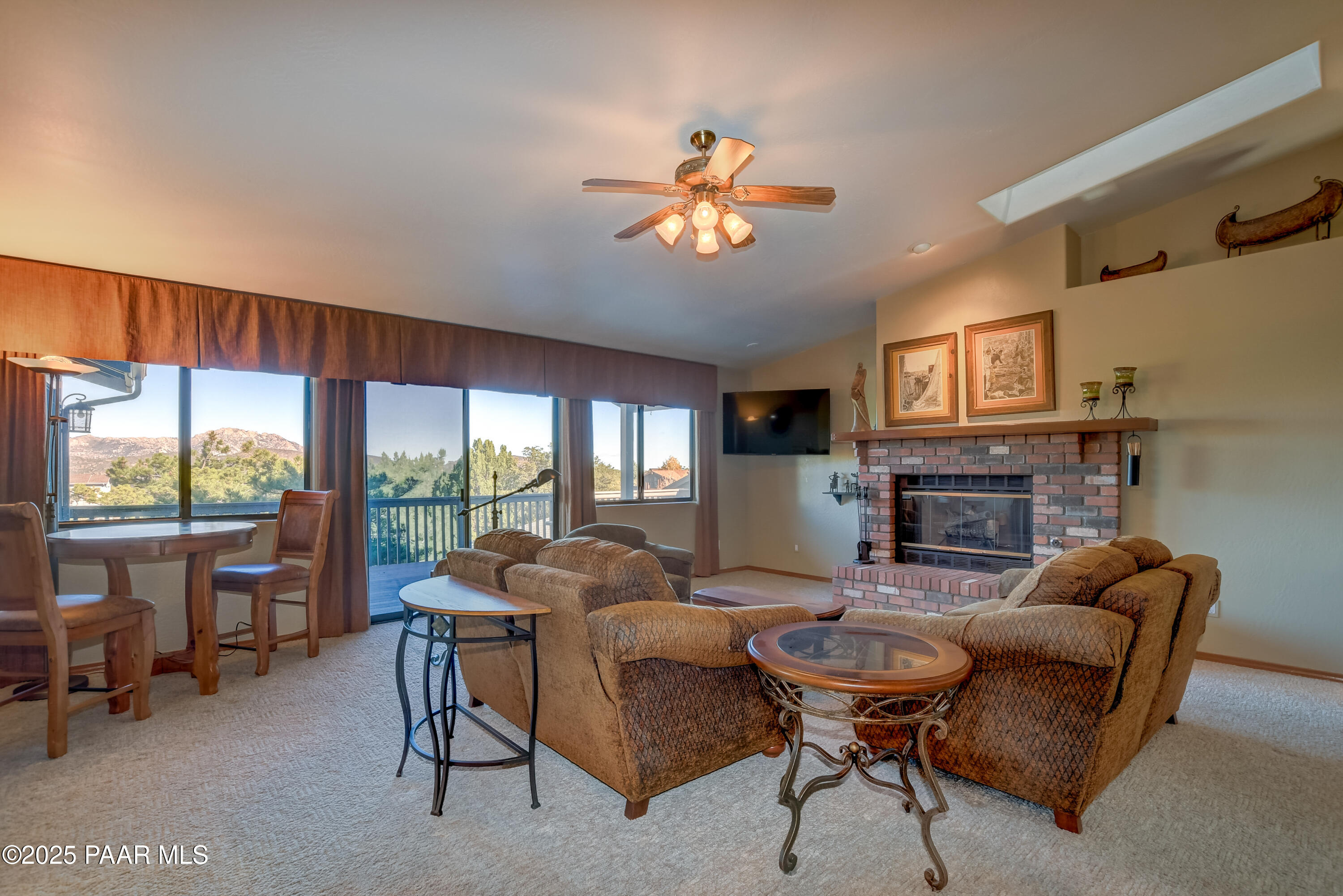 1881 Forest View Prescott, AZ 86305 - Photo 6 of 46 a living room with furniture a fireplace and a large window