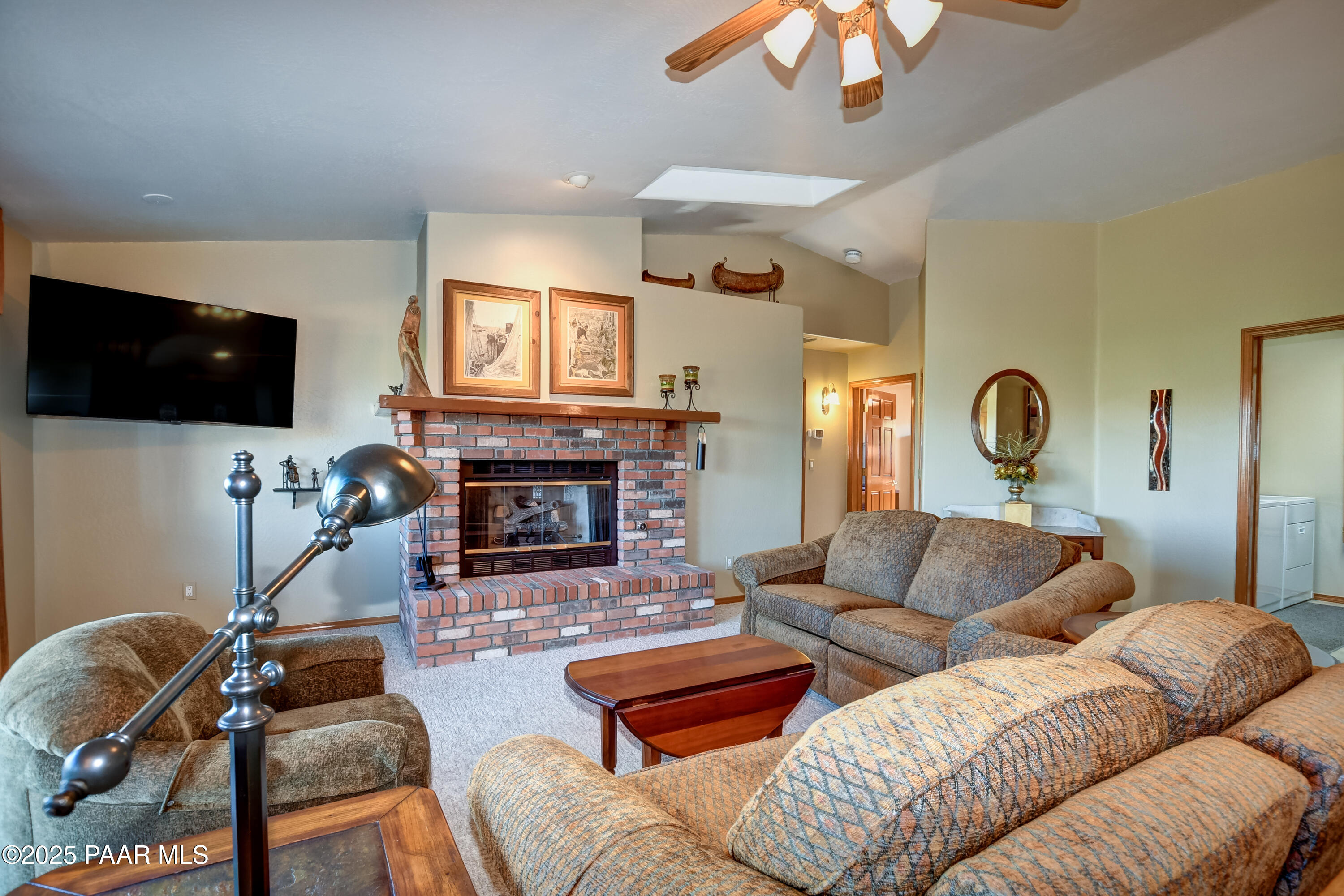 1881 Forest View Prescott, AZ 86305 - Photo 9 of 46 a living room with furniture a flat screen tv and a fireplace