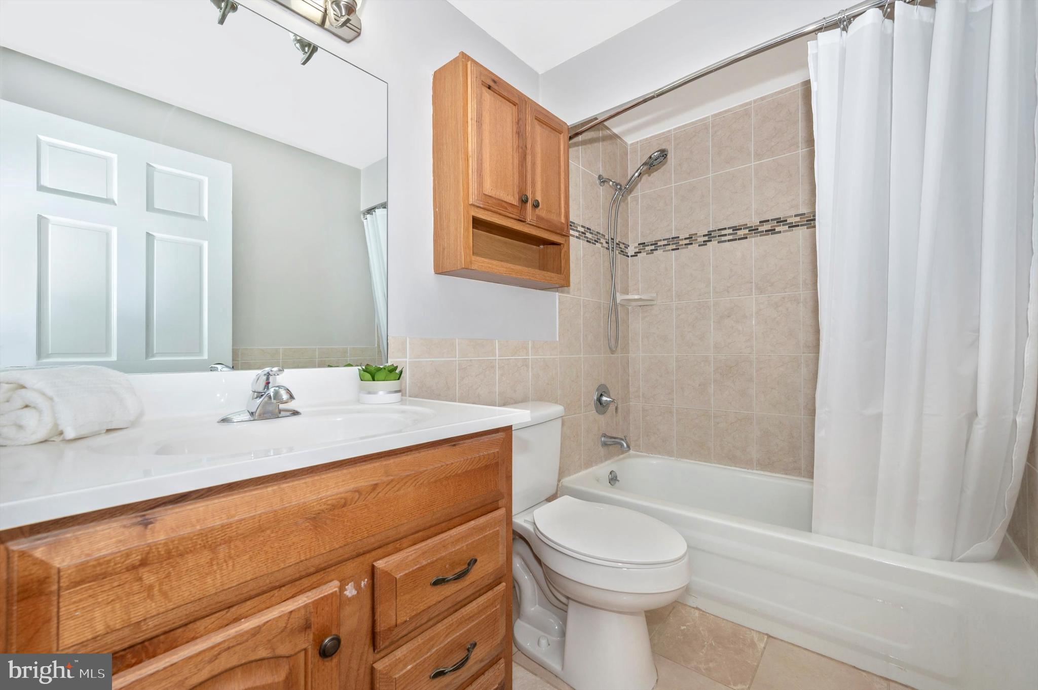 17526 Kohlhoss Road Poolesville, MD 20837 - Photo 23 of 42 a bathroom with a sink toilet and shower