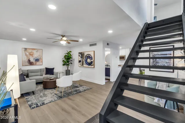 a living room with furniture and a ceiling fan